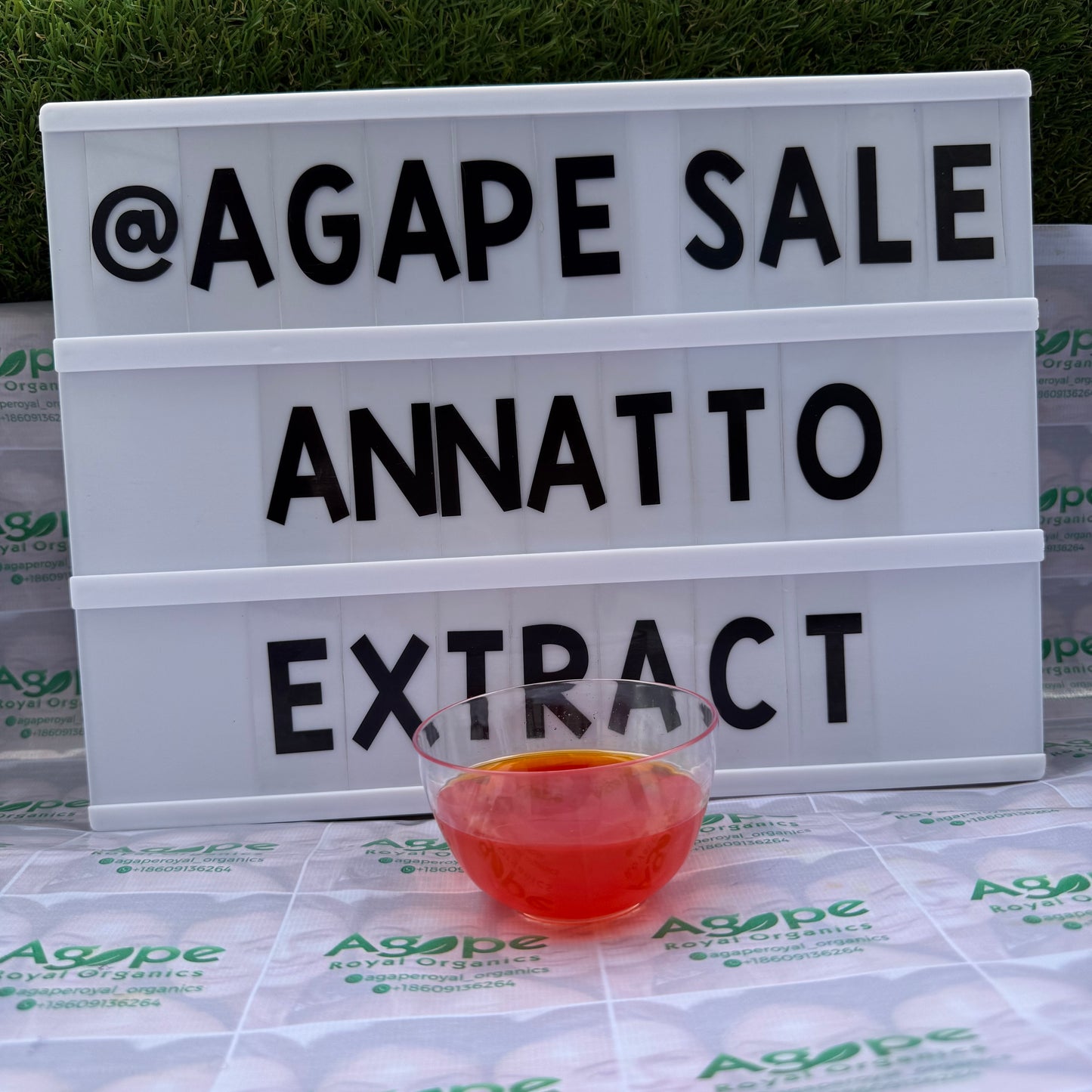Lightbox with 'AGAPE SALE ANNATTO EXTRACT' text on a branded background