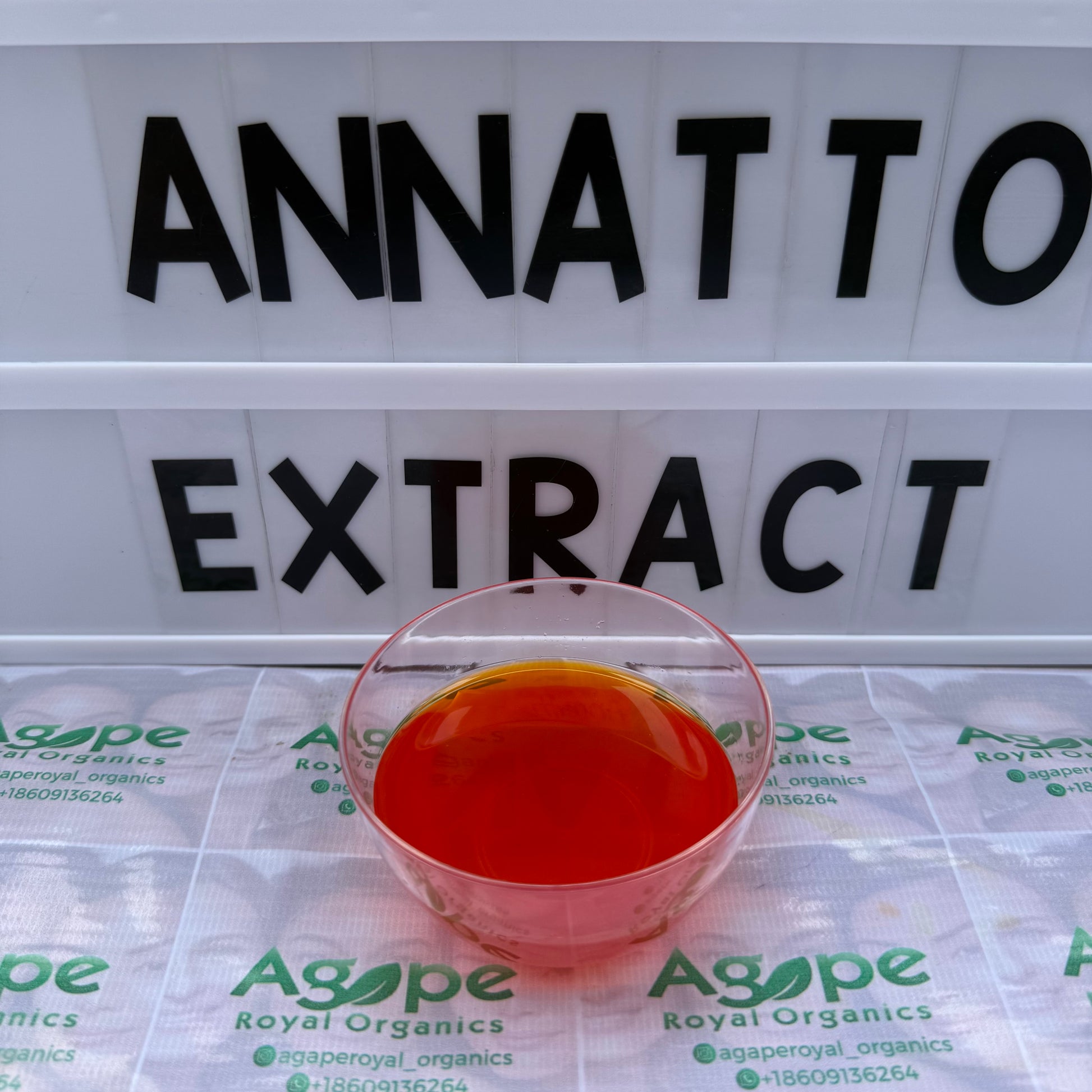 Red liquid in a small container with 'Agape' branding on a white background with text.